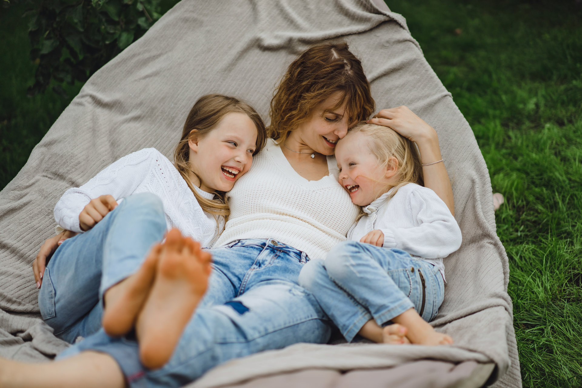 mother with children having fun in a hammock. Mom and kids in a